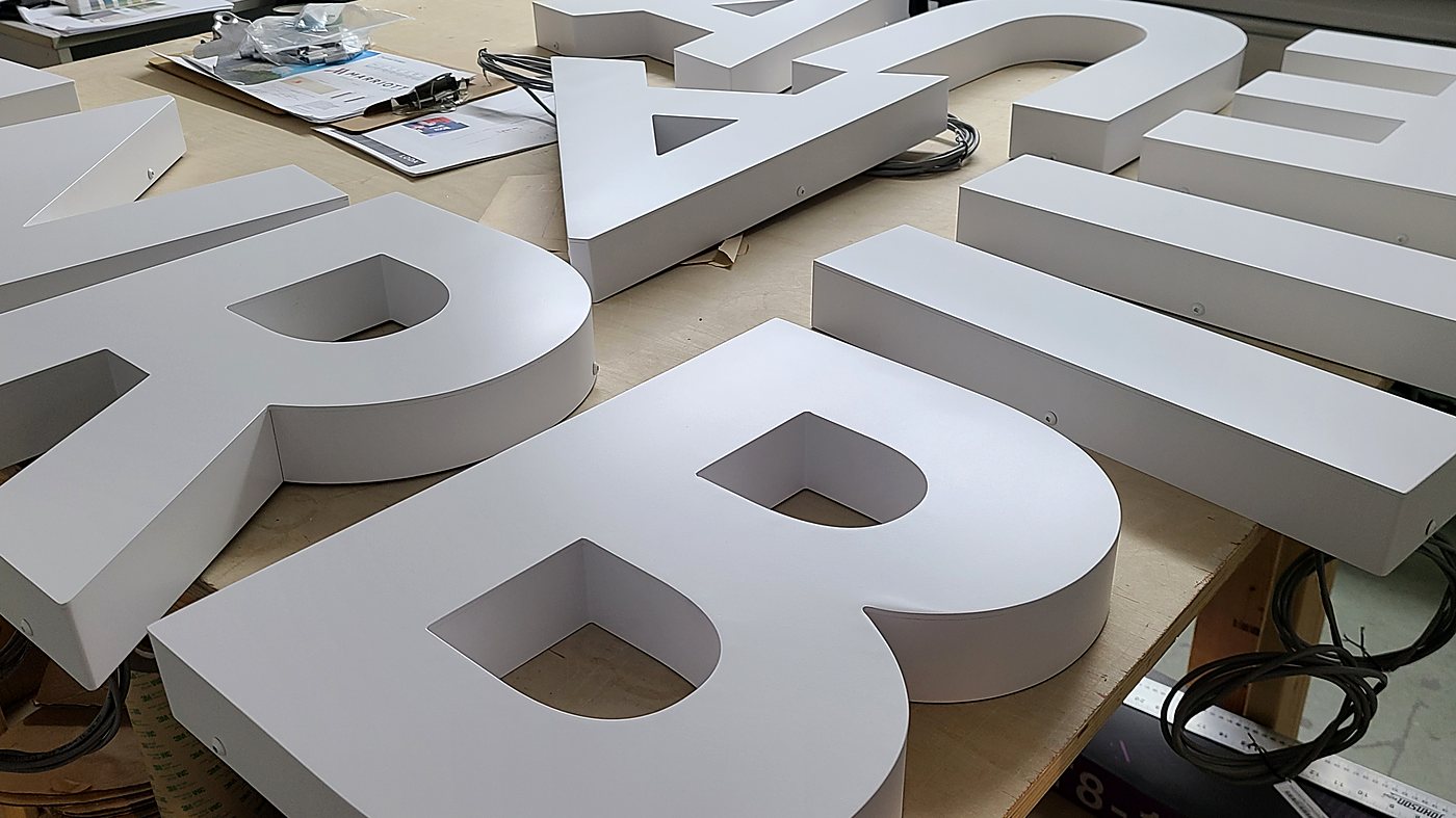 Backlit dimensional letters being prepped in the shop